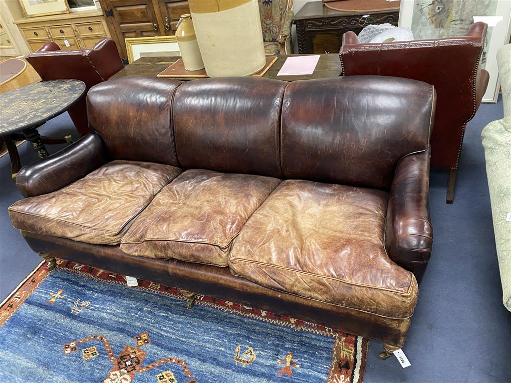 A George Smith Howard style brown leather three seater sofa, length 210cm, depth 106cm, height 84cm